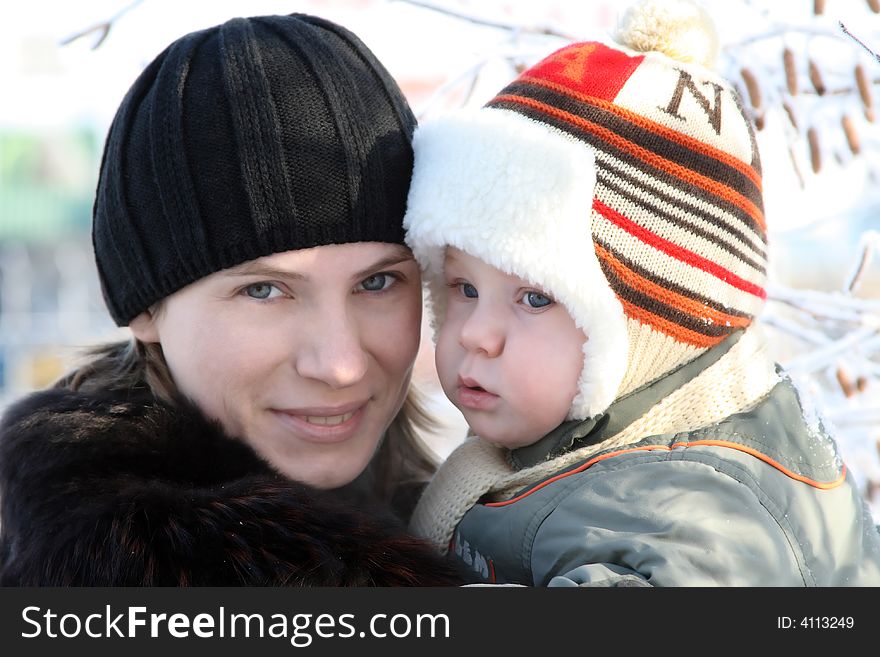 Portrait of mum with the son in the street in the winter