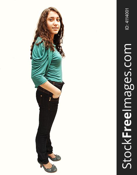 A young girl in jeans and turquoise sweater standing for white background. A young girl in jeans and turquoise sweater standing for white background.