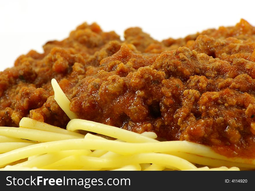 Fresh cooked white spaghetti pasta and juicy tomato meat sauce, often referred to as Italian Spaghetti, on white porcelain plate and white background. Close up macro. Fresh cooked white spaghetti pasta and juicy tomato meat sauce, often referred to as Italian Spaghetti, on white porcelain plate and white background. Close up macro.