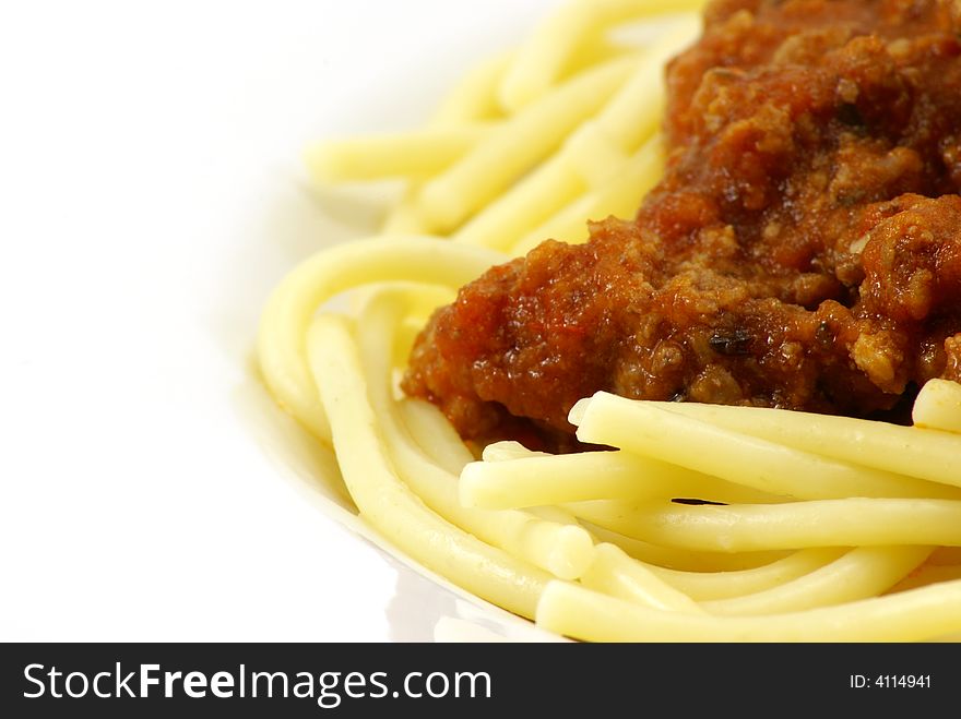 Fresh cooked white spaghetti pasta and juicy tomato meat sauce, often referred to as Italian Spaghetti, on white porcelain plate and white background. Close up macro. Fresh cooked white spaghetti pasta and juicy tomato meat sauce, often referred to as Italian Spaghetti, on white porcelain plate and white background. Close up macro.