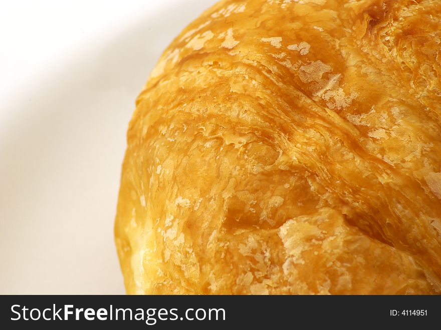 Extreme close up of Butter Croissant pastry on white background. Extreme close up of Butter Croissant pastry on white background.