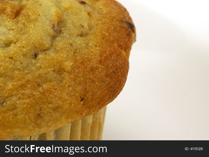 Fresh baked moist banana nut muffins on white plate and background.