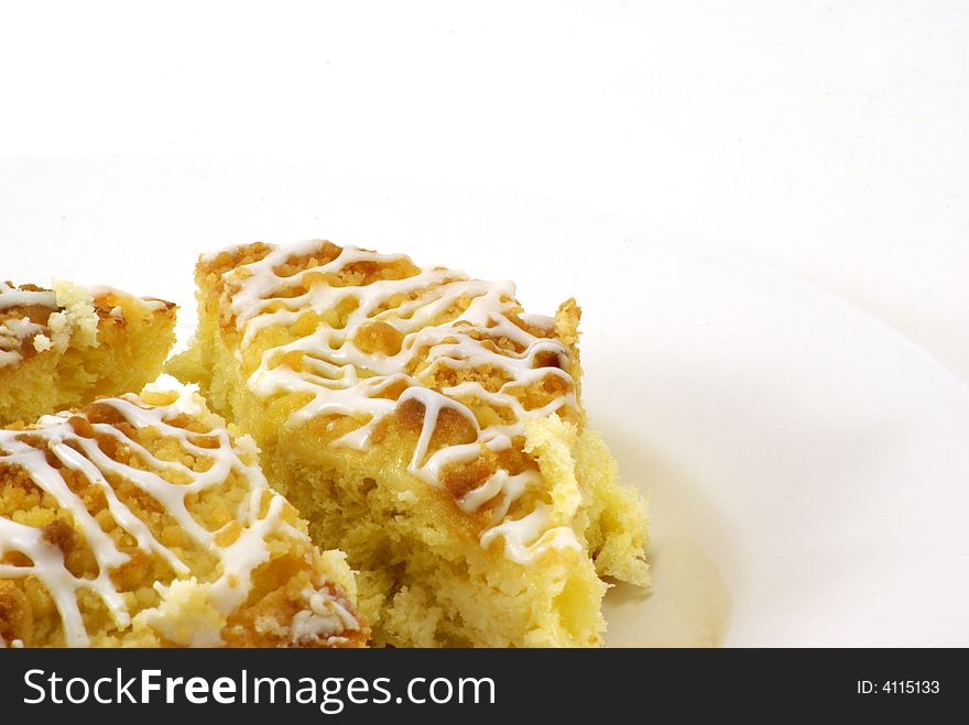 Fresh, moist pieces of streusel cheese coffee cake on white plate with white background. Fresh, moist pieces of streusel cheese coffee cake on white plate with white background.