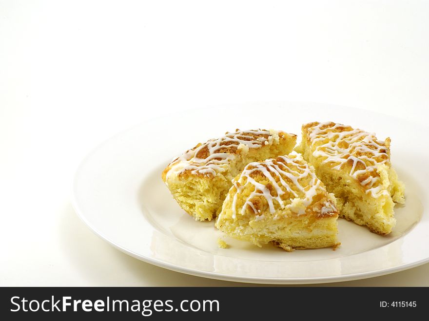 Fresh, moist pieces of streusel cheese coffee cake on white plate with white background. Fresh, moist pieces of streusel cheese coffee cake on white plate with white background.