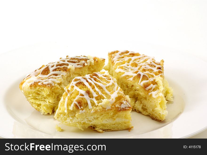 Fresh, moist pieces of streusel cheese coffee cake on white plate with white background. Fresh, moist pieces of streusel cheese coffee cake on white plate with white background.