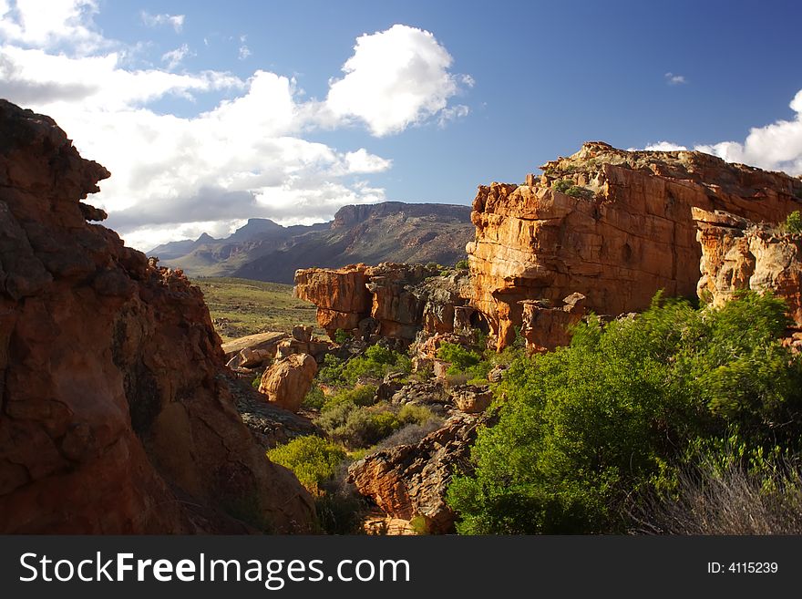 Landscape - yellow -red rocks against mountains- south africa. Landscape - yellow -red rocks against mountains- south africa
