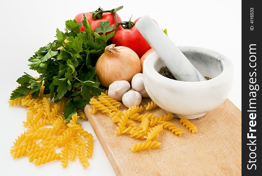 Tomatoes parsley garlic pasta spices and onion studio shot isolated. Tomatoes parsley garlic pasta spices and onion studio shot isolated