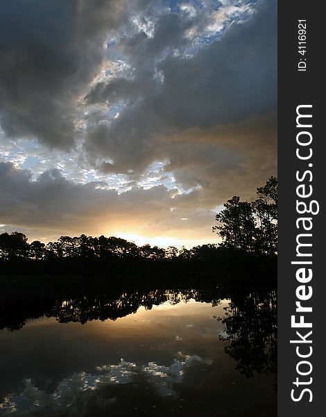 Scenic sunrise shot of the tree line in silhouette along the Neuse River in North Carolina. Scenic sunrise shot of the tree line in silhouette along the Neuse River in North Carolina.