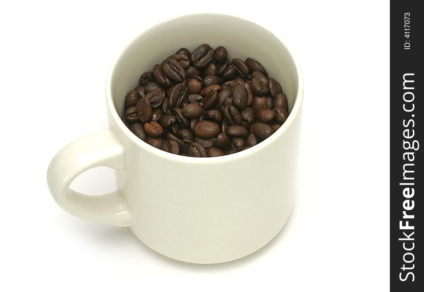 Studio isolated shot of coffee beans inside a typical white coffee mug, includes clipping path. Studio isolated shot of coffee beans inside a typical white coffee mug, includes clipping path.