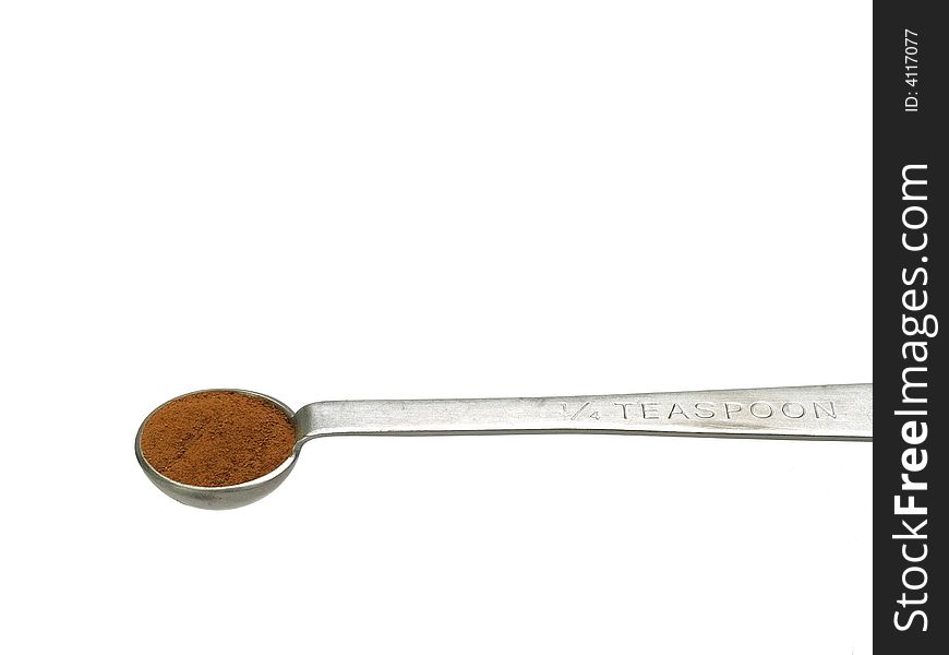 Studio isolated shot of cinnamon in a quarter-teaspoon, includes clipping path. Studio isolated shot of cinnamon in a quarter-teaspoon, includes clipping path.