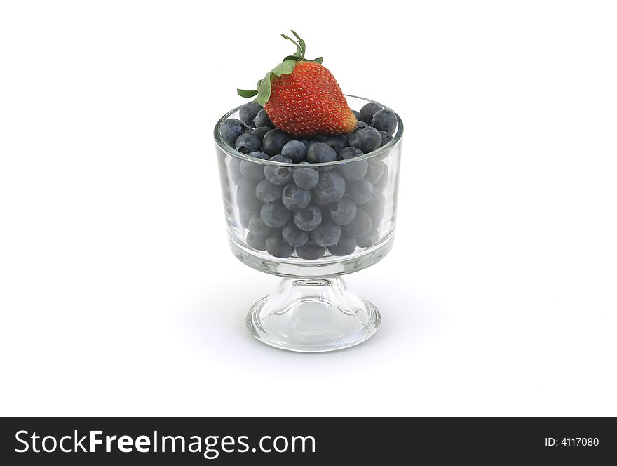 Bowl of organic blueberries and a strawberry, includes clipping path. Bowl of organic blueberries and a strawberry, includes clipping path.