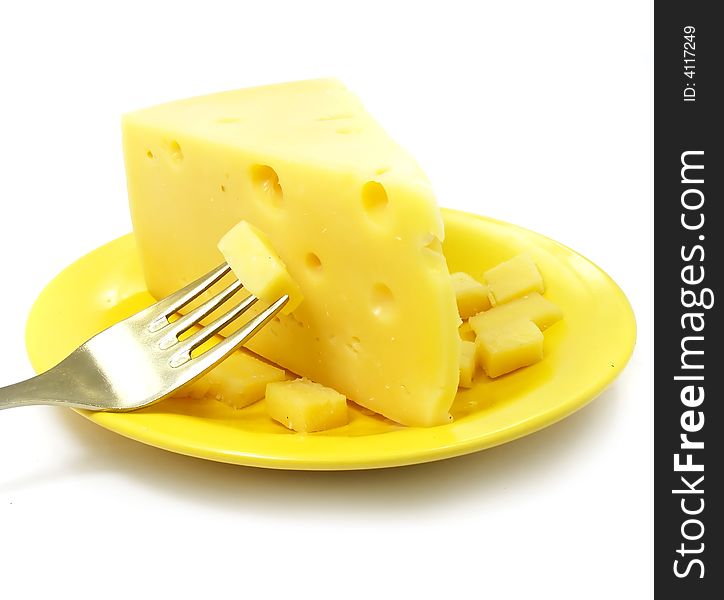 Piece of cheese on the plate with fork isolated over white background