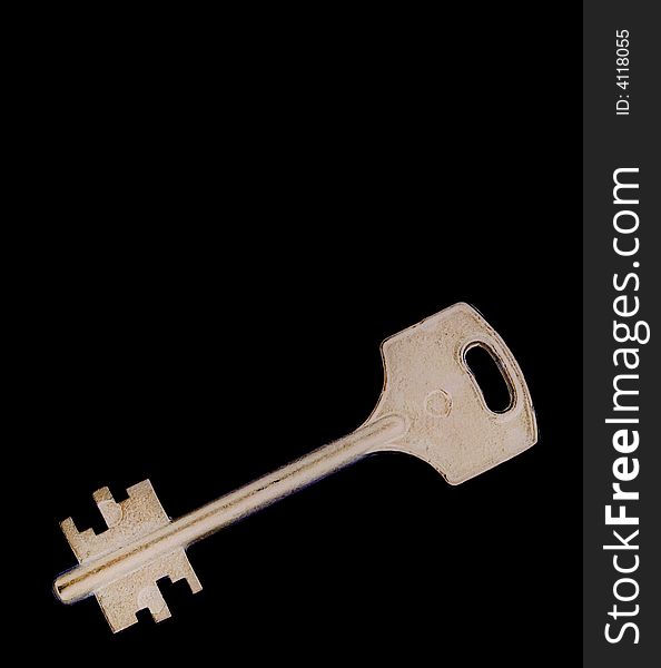 Old brass key isolated on black