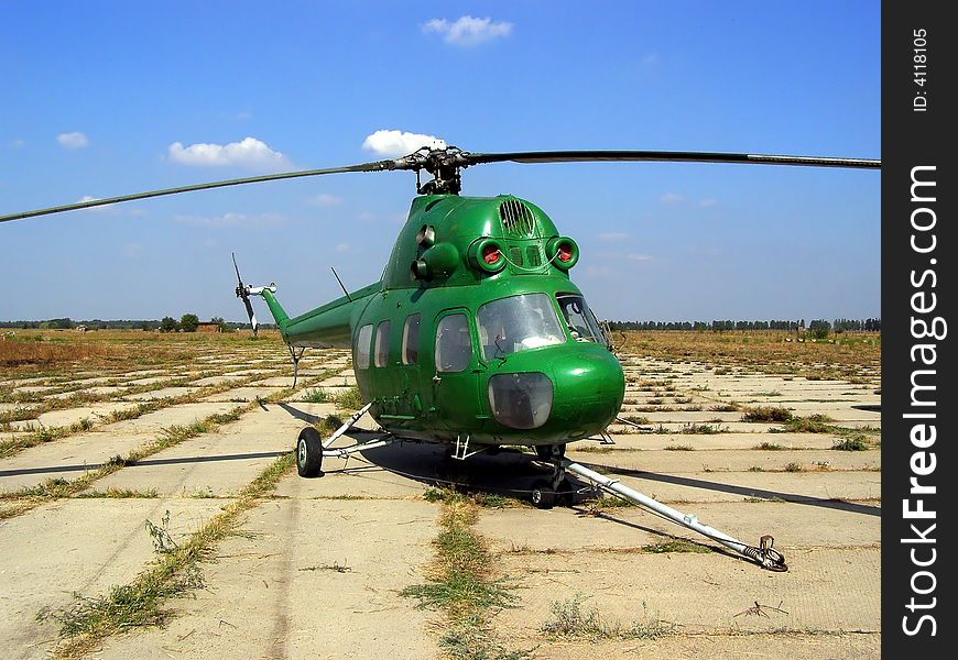 Old Green Mi Helocopter Standing on the Airfield. Old Green Mi Helocopter Standing on the Airfield