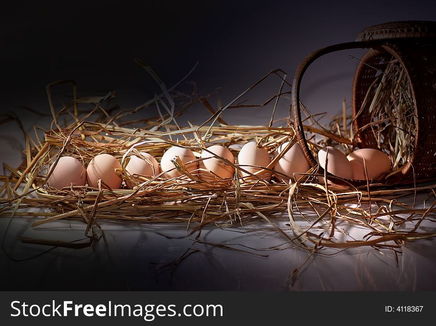 Fresh eggs on the rattan basket with straw. Fresh eggs on the rattan basket with straw