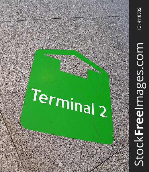 Sign arrow to terminal on the floor in airport. Sign arrow to terminal on the floor in airport