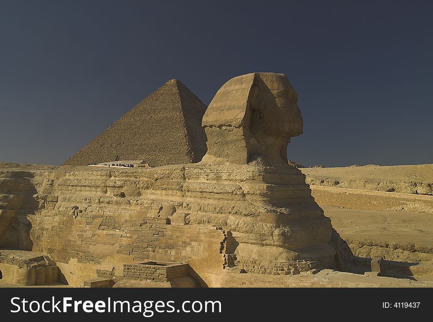 Sphinx with the great pyramid behind it Giza Cairo Egypt.