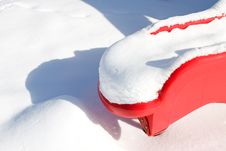 Red Plastic Slide In Snow Stock Photo