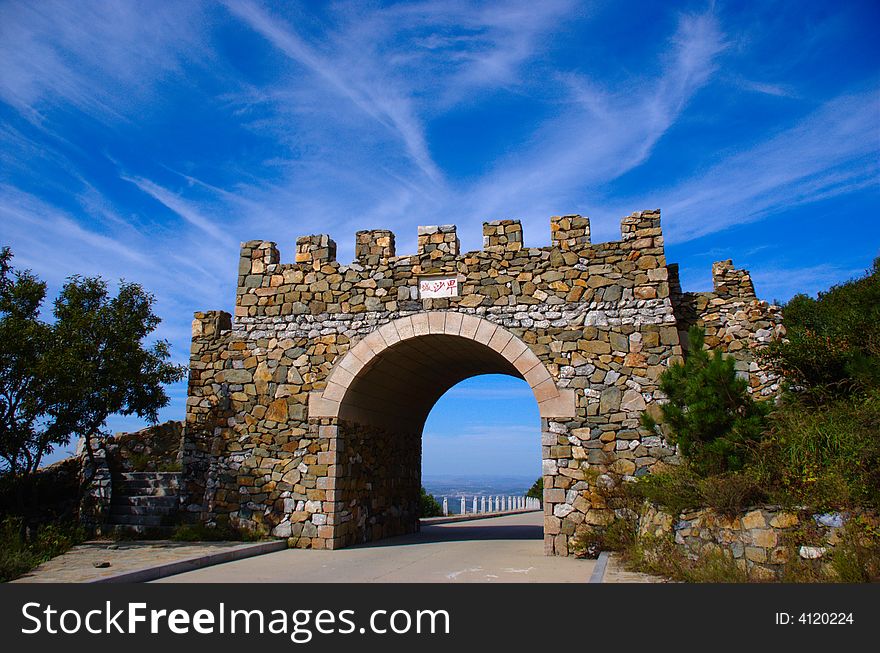 An ancient stone military gate built on a mountain. An ancient stone military gate built on a mountain