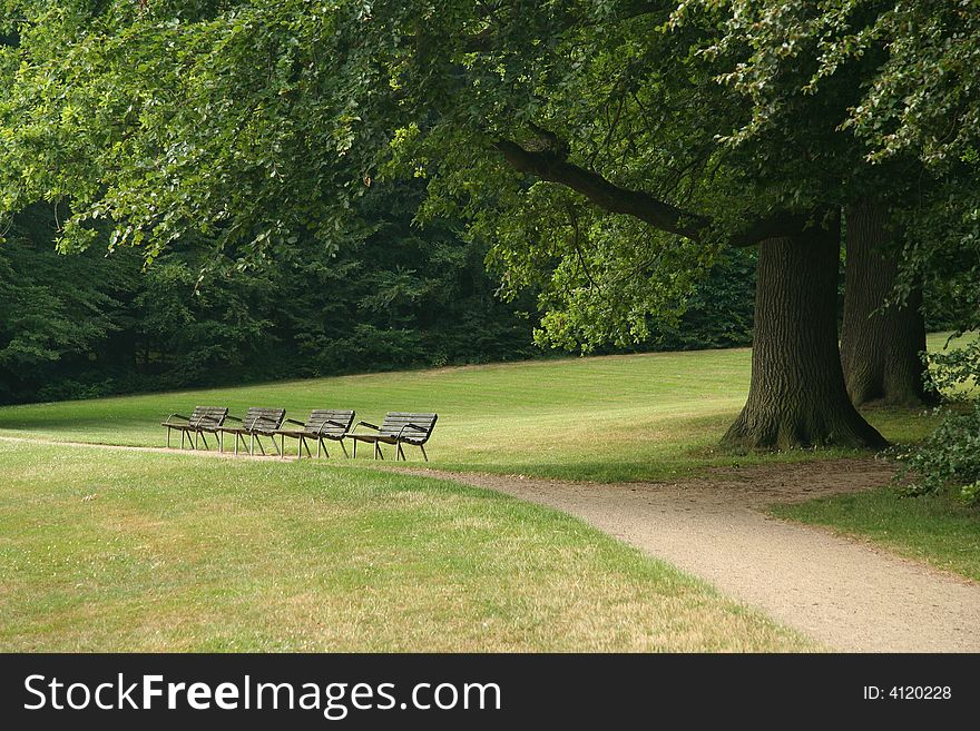 Strip of benches, park of Frederiksborg castle, Hilleroed, Denmark. Strip of benches, park of Frederiksborg castle, Hilleroed, Denmark