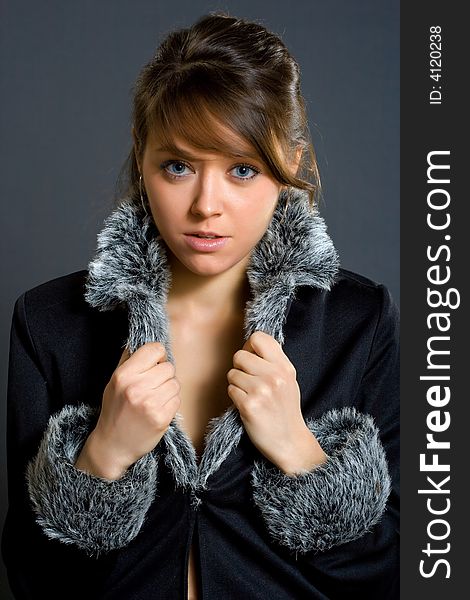 Woman in fur lined winter coat studio shot