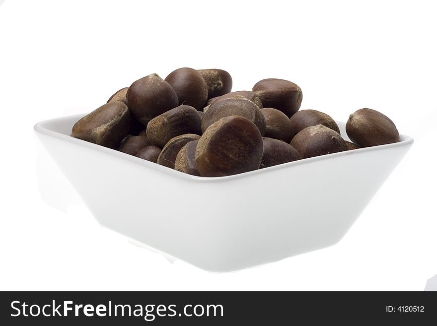 Chestnuts in the white bowl on white backgrounds