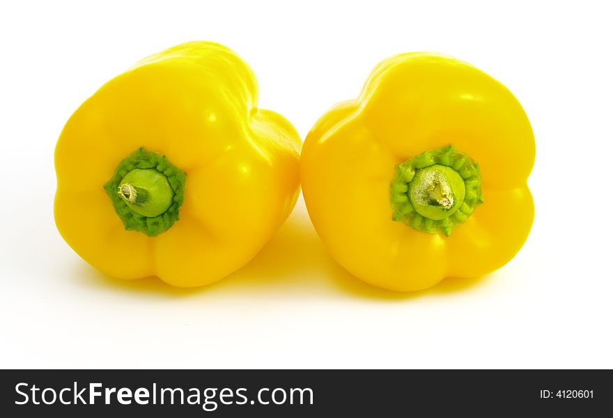 Two yellow peppers isolated on white background