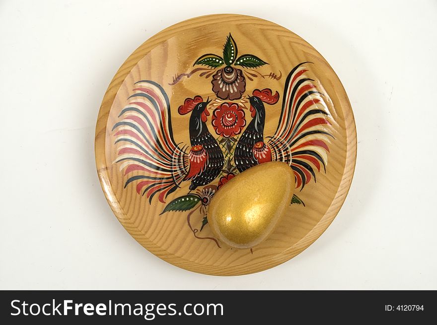 Colour wooden dish with figure and gold egg. Colour wooden dish with figure and gold egg.
