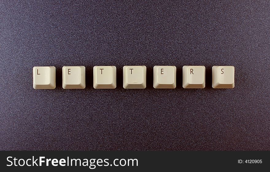 Computer keyboard letters on a dark background