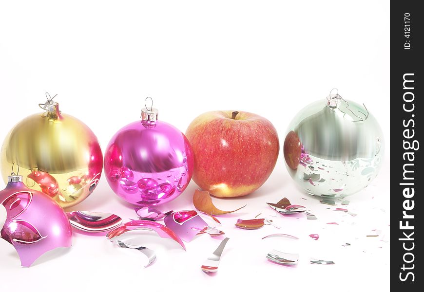 Christmas-tree decorations and apple on white  background