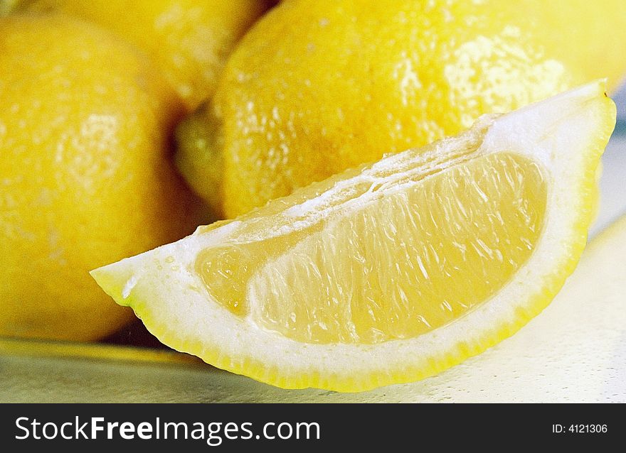 A close up view of a sliced lemon on a plate. A close up view of a sliced lemon on a plate