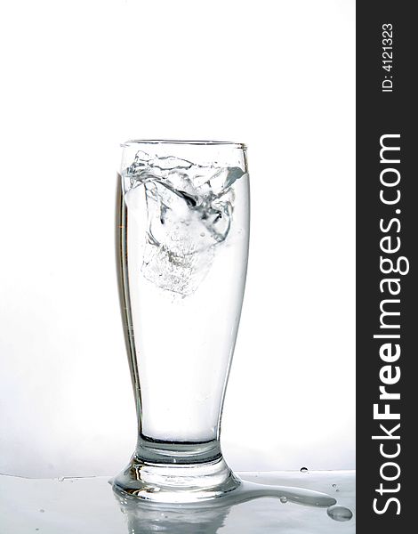 Water glass. Drink in movement. Liquid that it falls down in a glass.