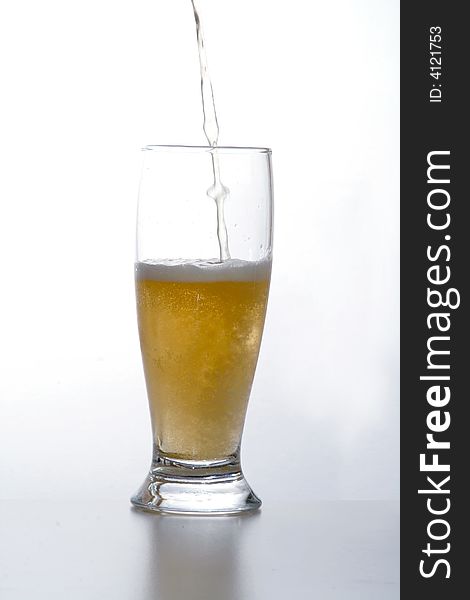 Glass of beer. Drink in movement. Liquid that it 

falls down in a glass.