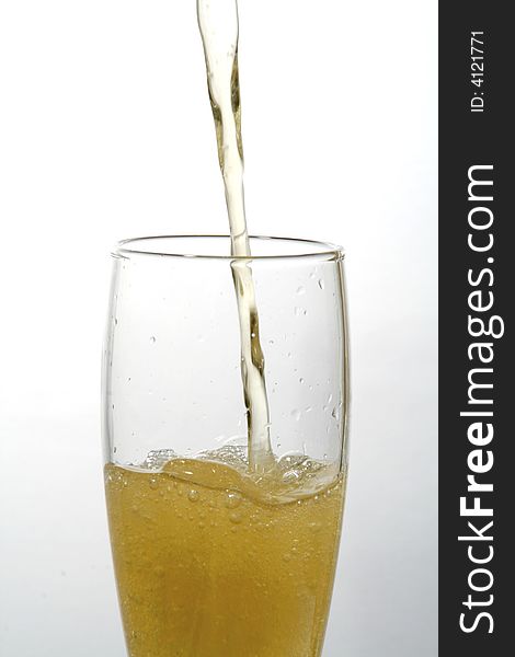 Glass of beer. Drink in movement. Liquid that it falls down in a glass.