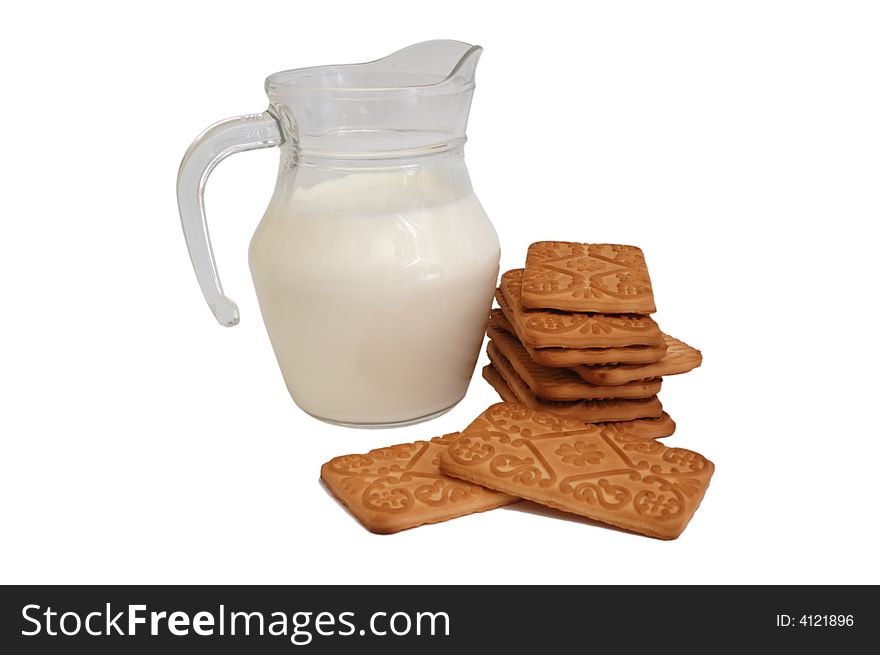 Glass jug with milk and cookies