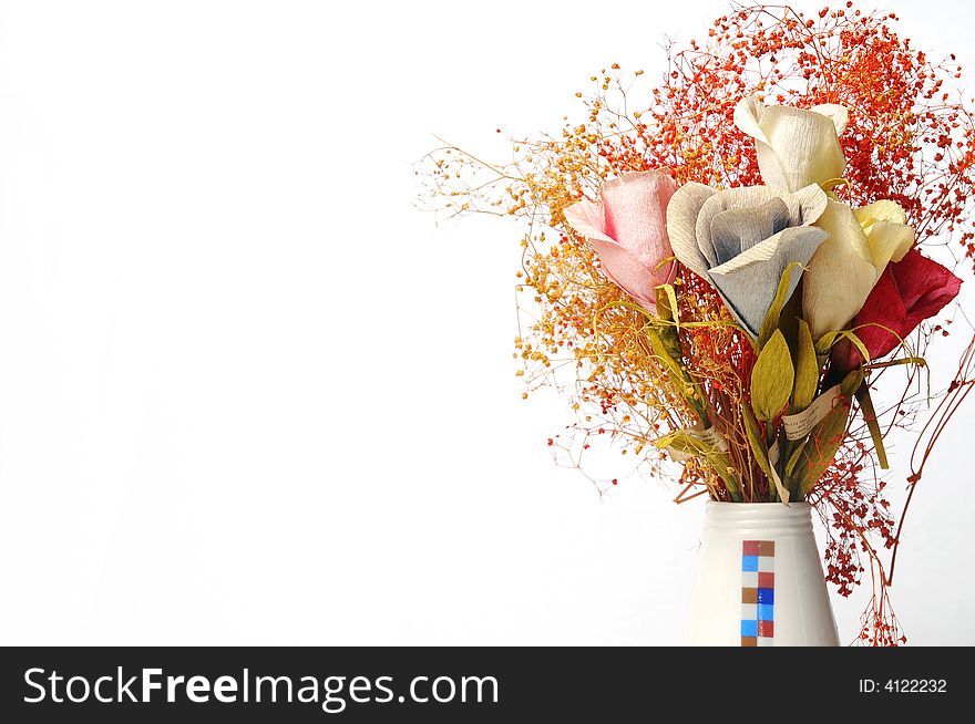 A vase of flowers and white background. A vase of flowers and white background