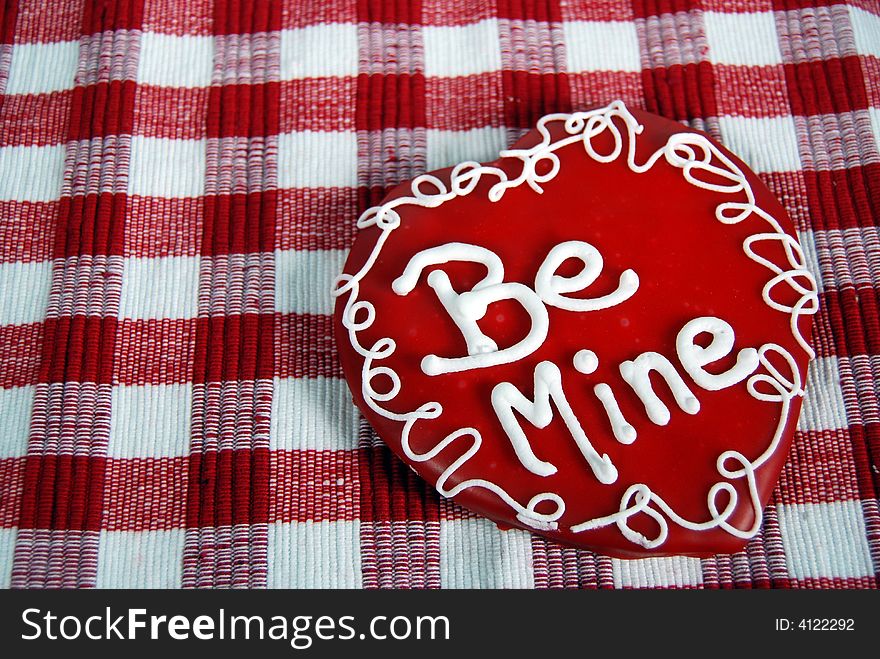 Valentine cookie on checkered tablecloth. Valentine cookie on checkered tablecloth.