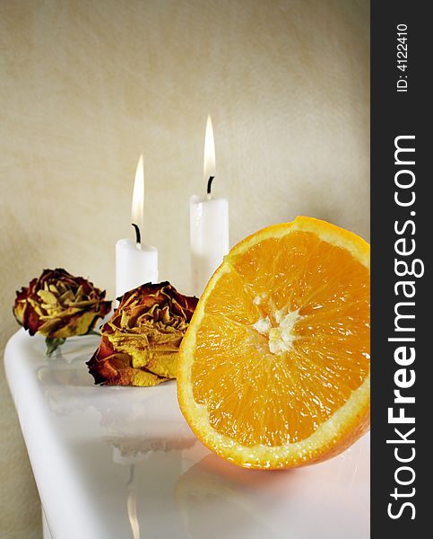 Fresh orange with roses and candlelights for some romance