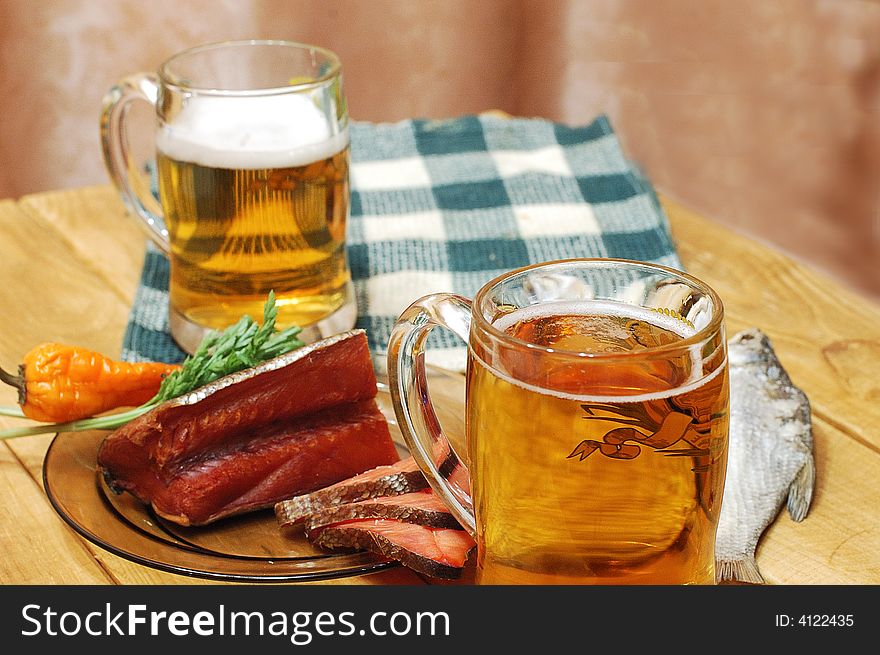 Mugs with beer and dried fishes. Mugs with beer and dried fishes