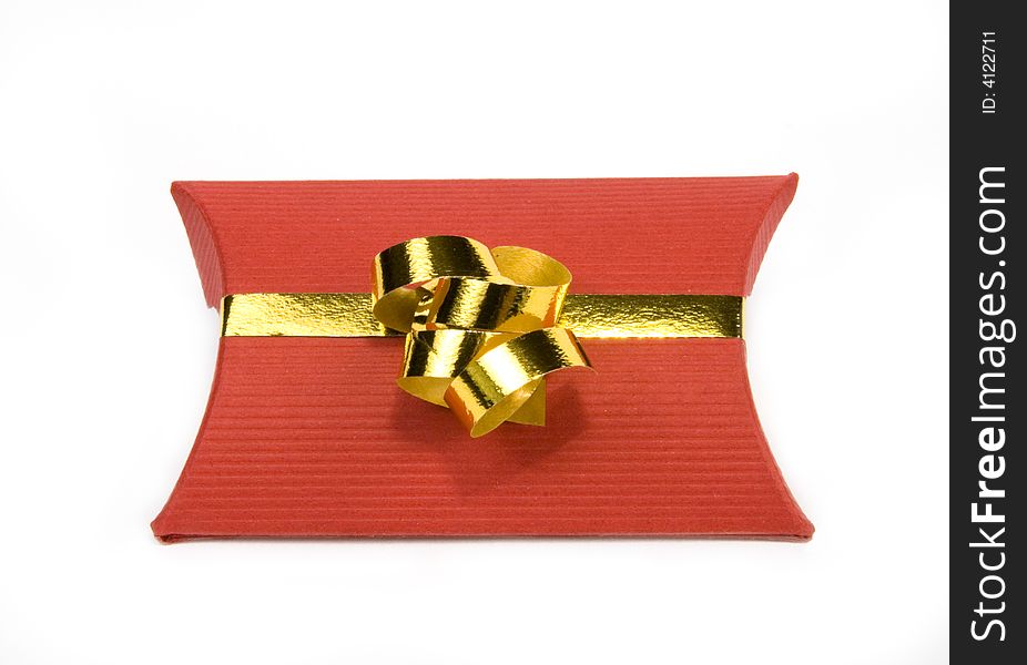 Red gift box with gold ribbon on white background