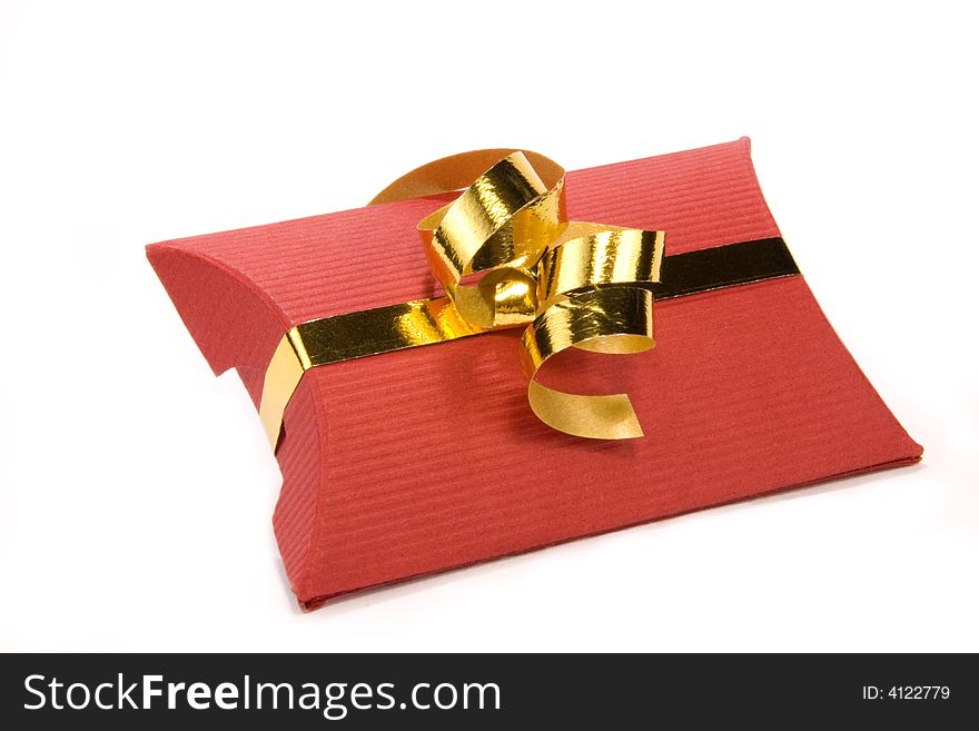 Red gift box with gold ribbon on white background