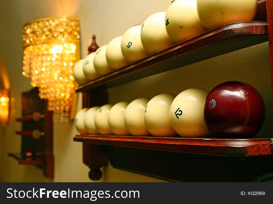 Spheres for game in billiards lay on a shelf. Spheres for game in billiards lay on a shelf