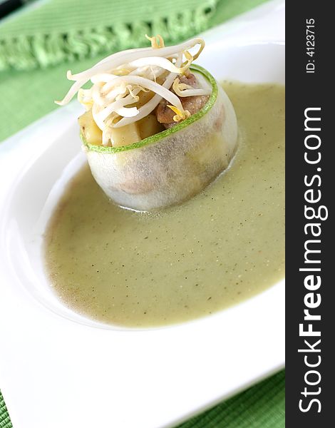 Cucumber wrapped chicken and potato chunks, topped with mung bean sprouts in cucumber sauce. Cucumber wrapped chicken and potato chunks, topped with mung bean sprouts in cucumber sauce