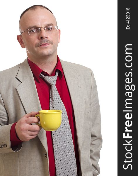 The man holds a yellow cup with tea. The man holds a yellow cup with tea