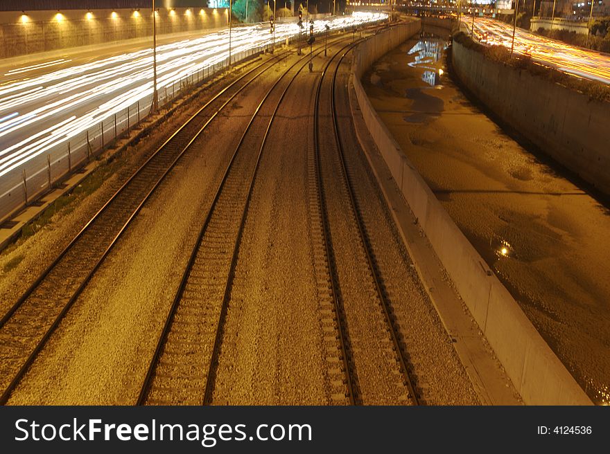 Highway and railroad tracks at night time. Highway and railroad tracks at night time.