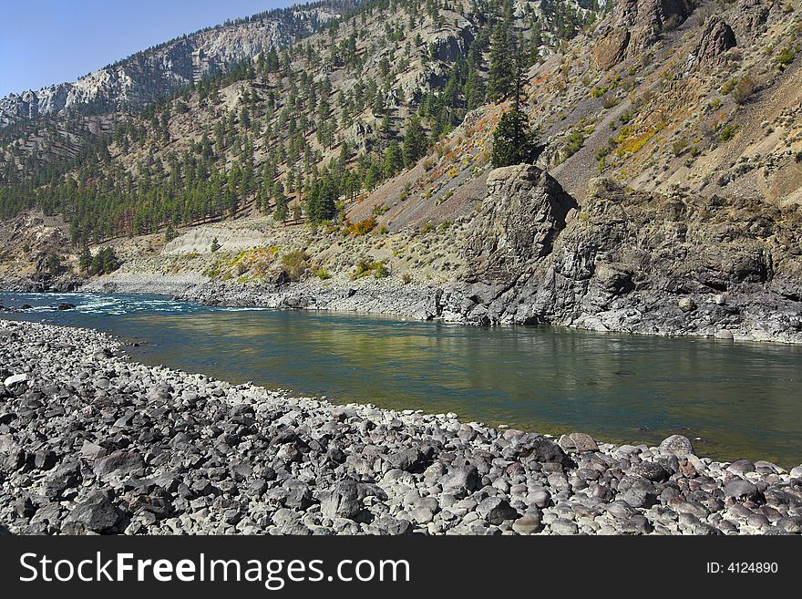 The rather narrow river in mountains of Canada. The rather narrow river in mountains of Canada