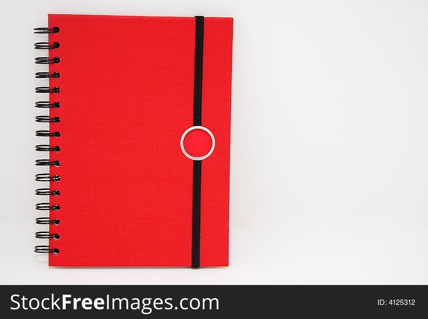 Red notebook shot on white , frontal view. Red notebook shot on white , frontal view