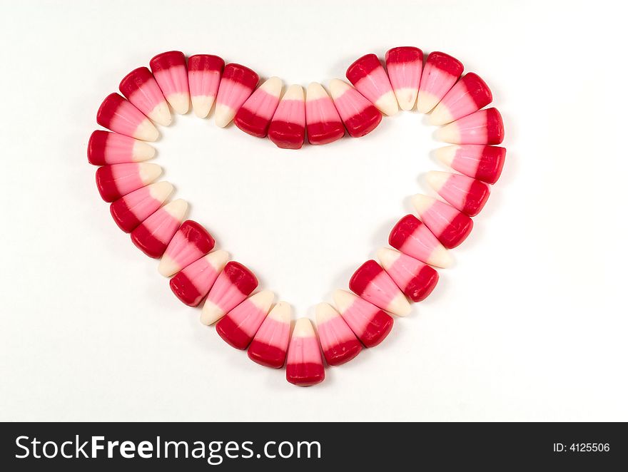 Candy Corns shaped in to a heart on a white background. Candy Corns shaped in to a heart on a white background.