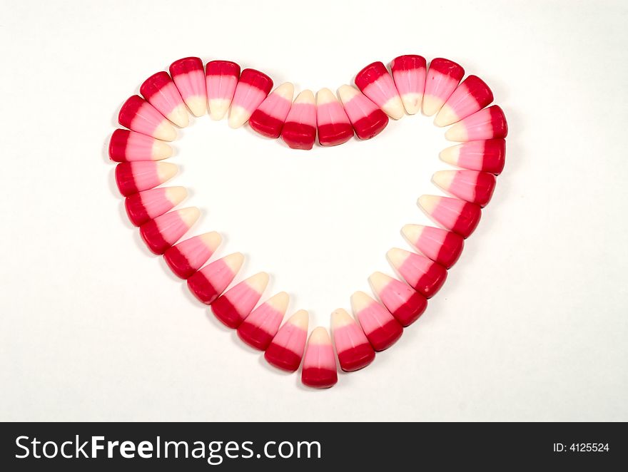 Candy Corns shaped in to a heart on a white background. Candy Corns shaped in to a heart on a white background.