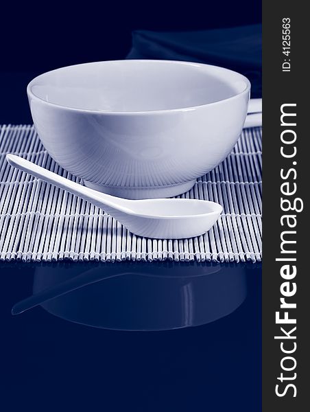 A table set for lunch with soup bowl and spoon. A table set for lunch with soup bowl and spoon